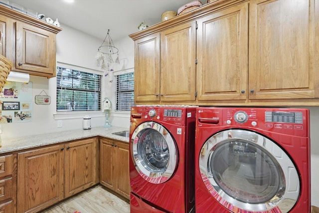3833 Montecito Dr, Denton, TX 76205 - laundry area with cabinet space, washer and clothes dryer, and light wood-style floors