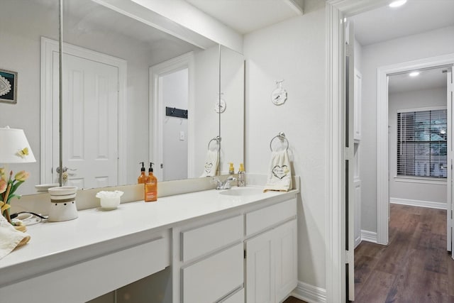 3833 Montecito Dr, Denton, TX 76205 - bathroom with vanity, wood finished floors, and baseboards