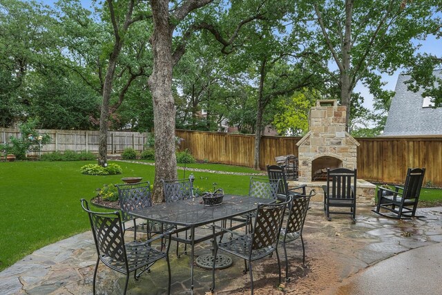 3833 Montecito Dr, Denton, TX 76205 - view of patio / terrace featuring an outdoor stone fireplace and outdoor dining area