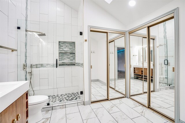 1705 Danube Ln, Plano, TX 75075 - full bath featuring marble look tiles, a stall shower, vanity, lofted ceiling, and toilet