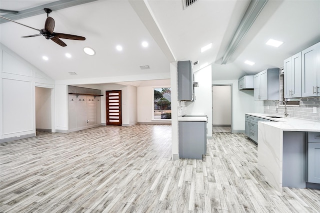 1705 Danube Ln, Plano, TX 75075 - kitchen featuring open floor plan, gray cabinets, a sink, light wood-style floors, and decorative backsplash