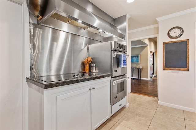 3330 Creekbend Dr, Garland, TX 75044 - kitchen featuring crown molding, dark countertops, black electric cooktop, baseboards, and double oven