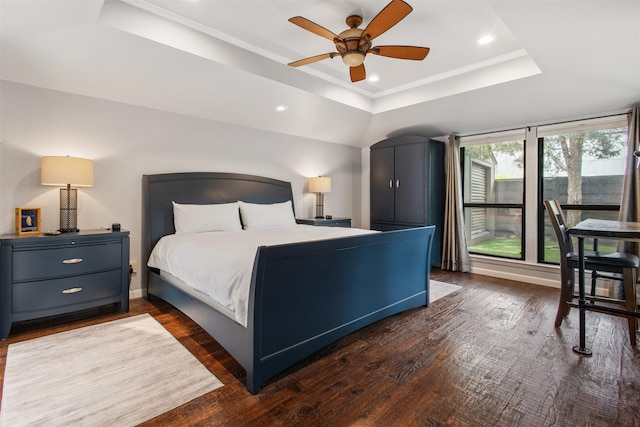 3330 Creekbend Dr, Garland, TX 75044 - bedroom featuring a tray ceiling, wood finished floors, recessed lighting, a ceiling fan, and baseboards