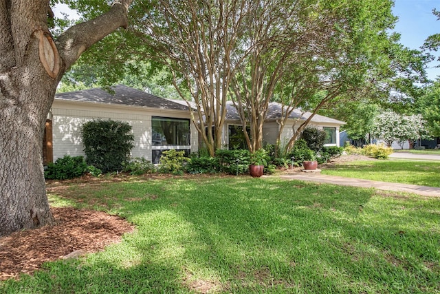 3330 Creekbend Dr, Garland, TX 75044 - ranch-style house featuring brick siding, a front yard, and a shingled roof
