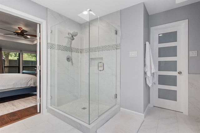 3330 Creekbend Dr, Garland, TX 75044 - ensuite bathroom with marble finish floors, ceiling fan, a stall shower, and baseboards