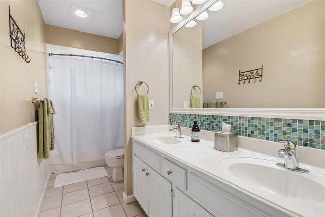 3330 Creekbend Dr, Garland, TX 75044 - full bath with toilet, double vanity, tile patterned floors, and shower / tub combo with curtain