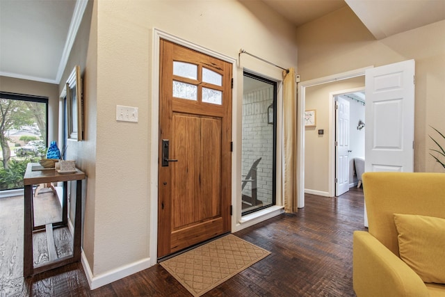 3330 Creekbend Dr, Garland, TX 75044 - foyer with ornamental molding, dark wood-style floors, and baseboards