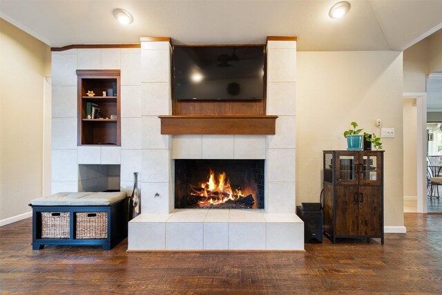 3330 Creekbend Dr, Garland, TX 75044 - living area featuring a tile fireplace, wood finished floors, and baseboards
