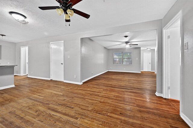 1306 Blanton Pl, Sherman, TX 75092 - unfurnished living room with a ceiling fan, dark wood-style floors, and a textured ceiling