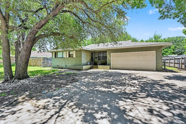 1306 Blanton Pl, Sherman, TX 75092 - view of front of property with brick siding, driveway, a garage, and board and batten siding