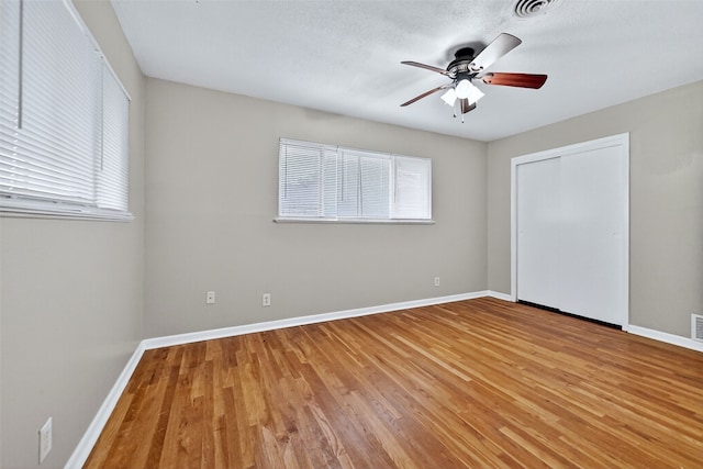 1306 Blanton Pl, Sherman, TX 75092 - unfurnished bedroom featuring multiple windows, light wood-style flooring, a closet, and a ceiling fan