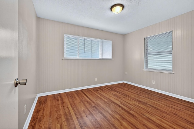 1306 Blanton Pl, Sherman, TX 75092 - spare room with wood finished floors and a textured ceiling