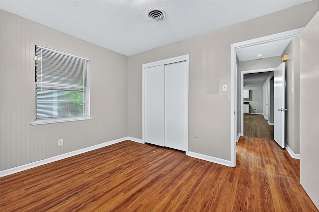 1306 Blanton Pl, Sherman, TX 75092 - unfurnished bedroom featuring wood finished floors and a closet