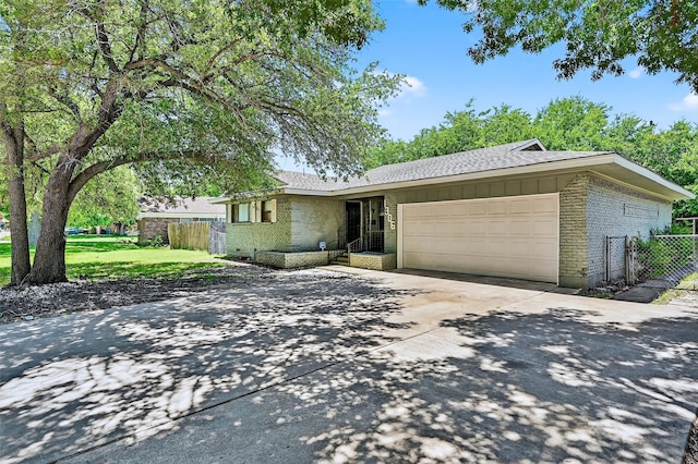 1306 Blanton Pl, Sherman, TX 75092 - ranch-style house featuring brick siding, a garage, driveway, and roof with shingles