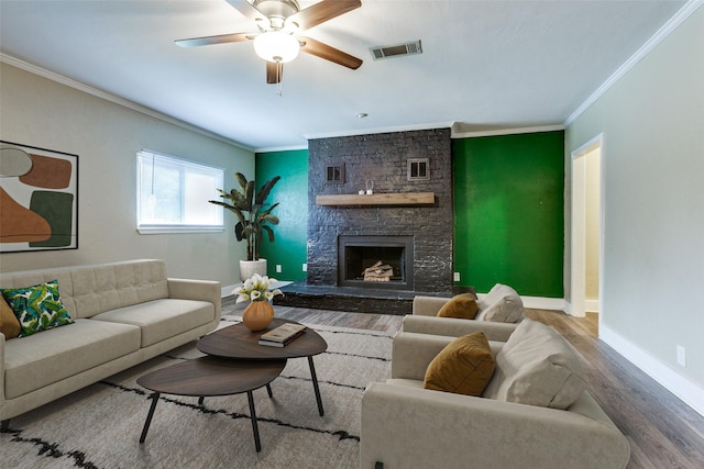 801 Northshore Dr, Garland, TX 75040 - living area with ornamental molding, wood finished floors, baseboards, a stone fireplace, and ceiling fan