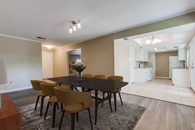 801 Northshore Dr, Garland, TX 75040 - dining space featuring light wood-style floors, ornamental molding, and baseboards