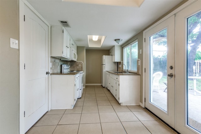 801 Northshore Dr, Garland, TX 75040 - kitchen featuring white appliances, a sink, dark countertops, decorative backsplash, and light tile patterned floors