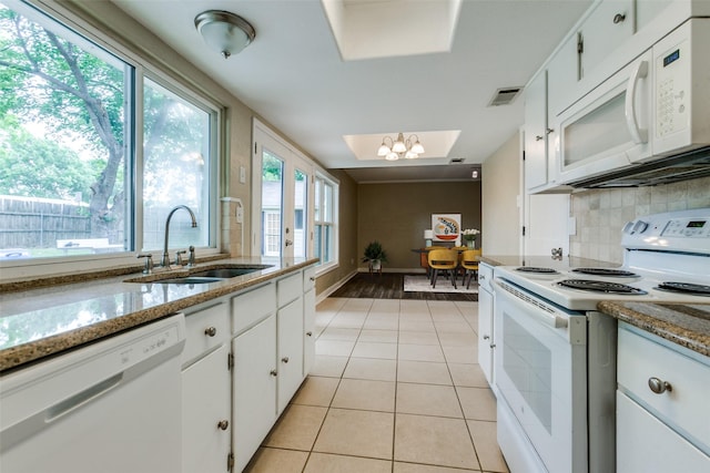 801 Northshore Dr, Garland, TX 75040 - kitchen with white appliances, a sink, light tile patterned floors, white cabinets, and decorative backsplash
