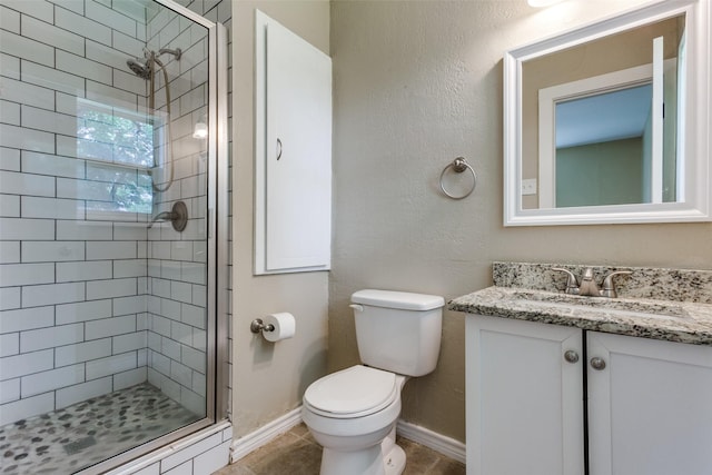 801 Northshore Dr, Garland, TX 75040 - full bath featuring vanity, a shower stall, toilet, tile patterned floors, and baseboards