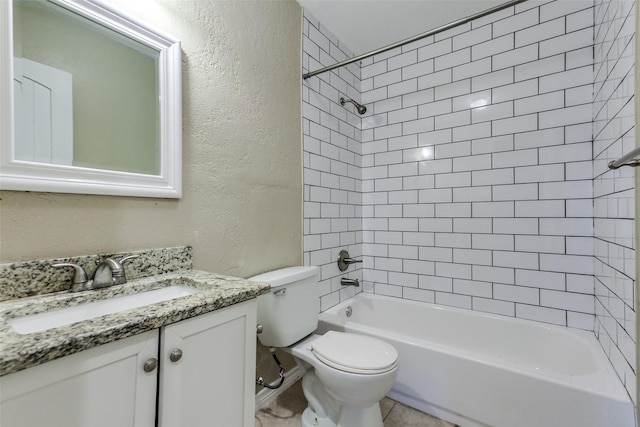 801 Northshore Dr, Garland, TX 75040 - bathroom with a textured wall, vanity, toilet, washtub / shower combination, and tile patterned flooring