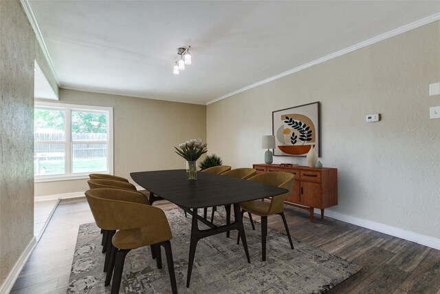 801 Northshore Dr, Garland, TX 75040 - dining space featuring dark wood finished floors, crown molding, and baseboards