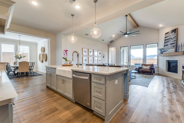 3109 Twin Eagles Dr, Celina, TX 75009 - kitchen with gray cabinets, stainless steel dishwasher, a sink, light wood-style flooring, and recessed lighting
