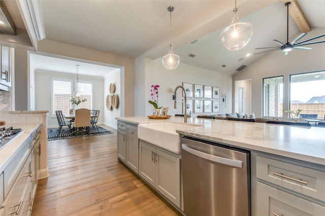 3109 Twin Eagles Dr, Celina, TX 75009 - kitchen with appliances with stainless steel finishes, gray cabinetry, a sink, light wood-type flooring, and a ceiling fan