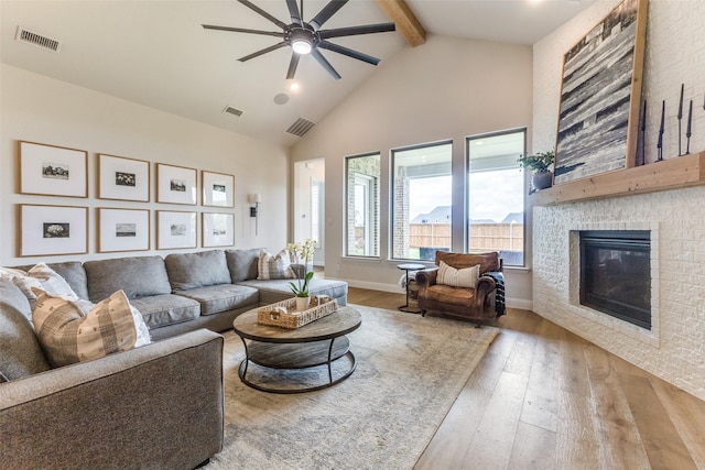 3109 Twin Eagles Dr, Celina, TX 75009 - living area featuring beamed ceiling, ceiling fan, hardwood / wood-style floors, a fireplace, and high vaulted ceiling