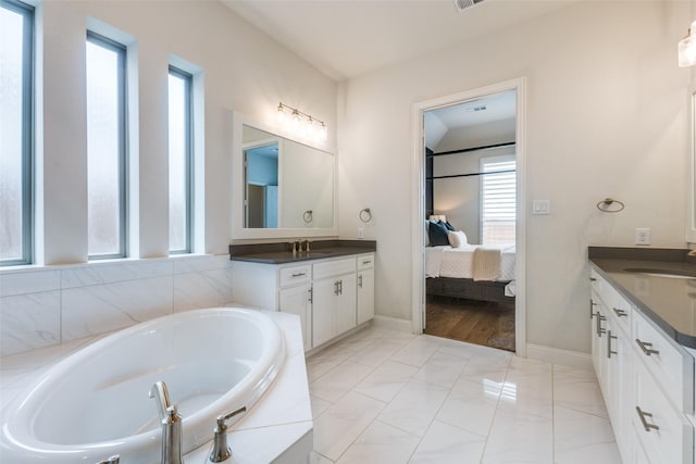 3109 Twin Eagles Dr, Celina, TX 75009 - full bathroom featuring vanity, a bath, connected bathroom, and marble look tiles