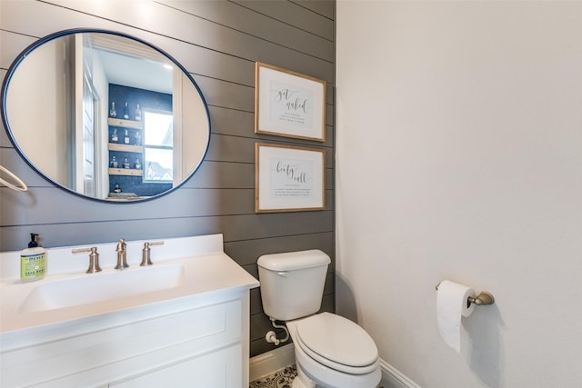3109 Twin Eagles Dr, Celina, TX 75009 - half bathroom featuring toilet, vanity, wood walls, and baseboards