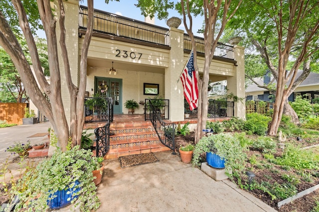 2307 5th Ave, Fort Worth, TX 76110 - doorway to property featuring brick siding, a porch, and a balcony