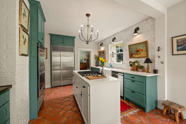 2307 5th Ave, Fort Worth, TX 76110 - kitchen with stainless steel appliances, green cabinetry, a chandelier, and light countertops
