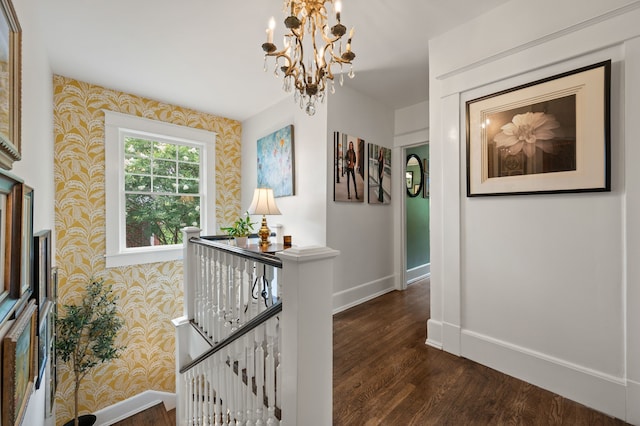2307 5th Ave, Fort Worth, TX 76110 - hall featuring wallpapered walls, baseboards, wood finished floors, a chandelier, and an upstairs landing