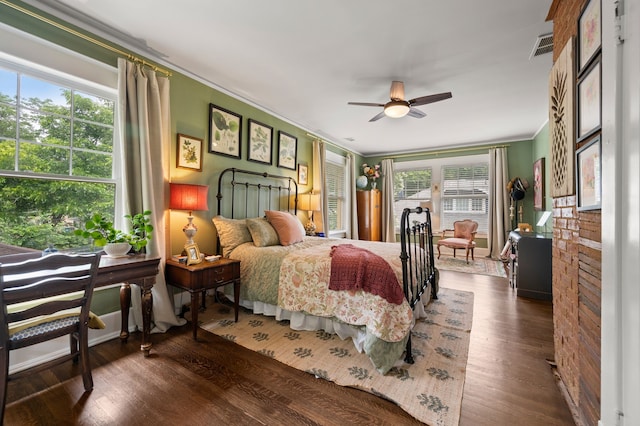 2307 5th Ave, Fort Worth, TX 76110 - bedroom with multiple windows, ornamental molding, wood finished floors, and ceiling fan