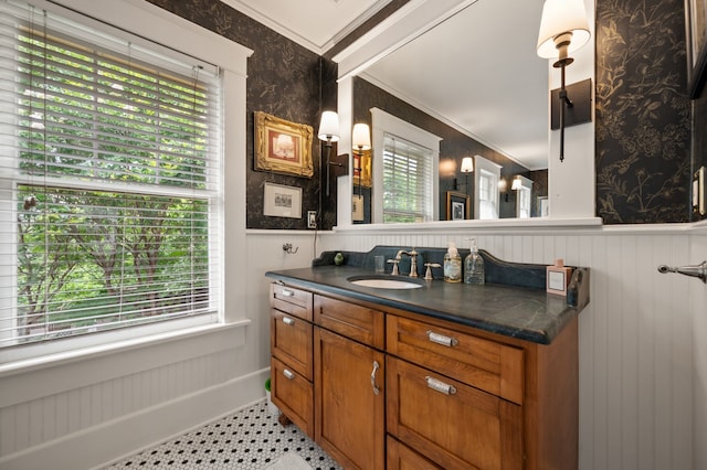 2307 5th Ave, Fort Worth, TX 76110 - bathroom with wainscoting, vanity, crown molding, and baseboards