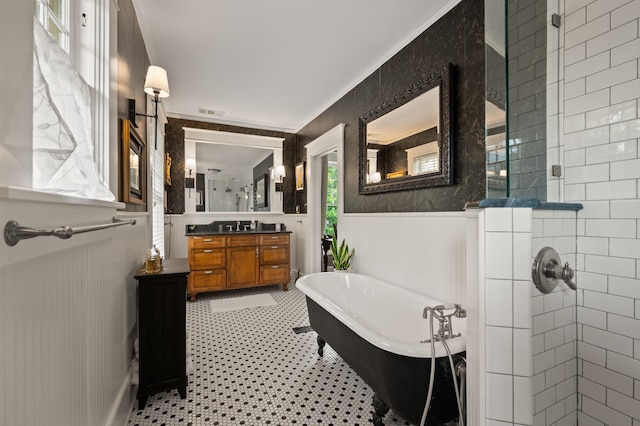 2307 5th Ave, Fort Worth, TX 76110 - full bath featuring a shower stall, a freestanding bath, vanity, and wainscoting