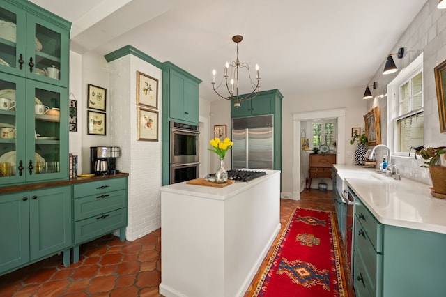 2307 5th Ave, Fort Worth, TX 76110 - kitchen featuring appliances with stainless steel finishes, a chandelier, a sink, green cabinetry, and hanging light fixtures