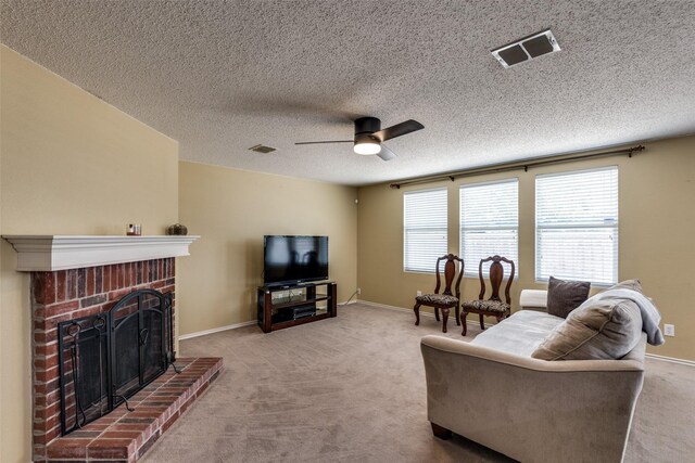 5504 Cedar Mountain Dr, Mckinney, TX 75071 - carpeted living area featuring a ceiling fan, a brick fireplace, baseboards, and a textured ceiling