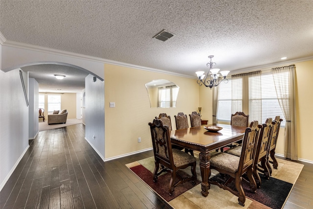 5504 Cedar Mountain Dr, Mckinney, TX 75071 - dining space featuring arched walkways, crown molding, wood-type flooring, a chandelier, and a textured ceiling