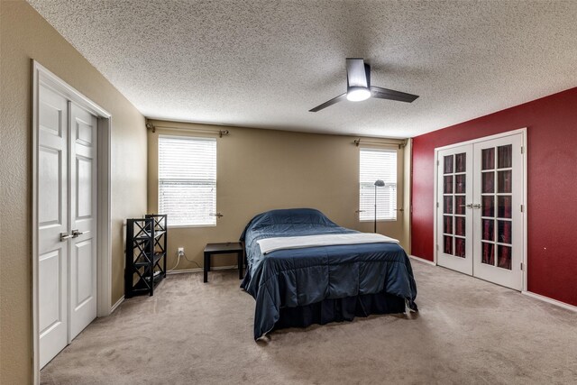 5504 Cedar Mountain Dr, Mckinney, TX 75071 - carpeted bedroom with french doors, multiple windows, ceiling fan, a textured ceiling, and baseboards