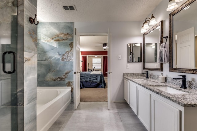 5504 Cedar Mountain Dr, Mckinney, TX 75071 - ensuite bathroom featuring a textured ceiling, double vanity, a garden tub, an enclosed shower, and ceiling fan