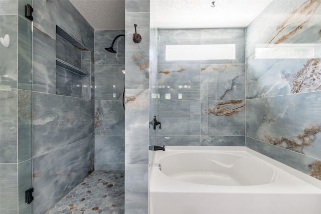 5504 Cedar Mountain Dr, Mckinney, TX 75071 - bathroom featuring a bathtub, a tile shower, and a textured ceiling