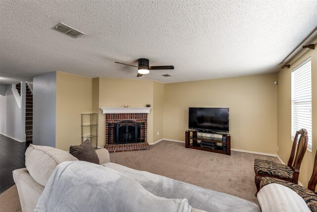 5504 Cedar Mountain Dr, Mckinney, TX 75071 - living room featuring ceiling fan, stairs, a fireplace, baseboards, and a textured ceiling