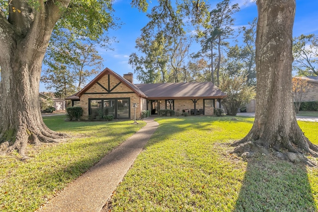 500 Cynthia Dr, Longview, TX 75605 - view of front of home featuring a front lawn, a chimney, and brick siding