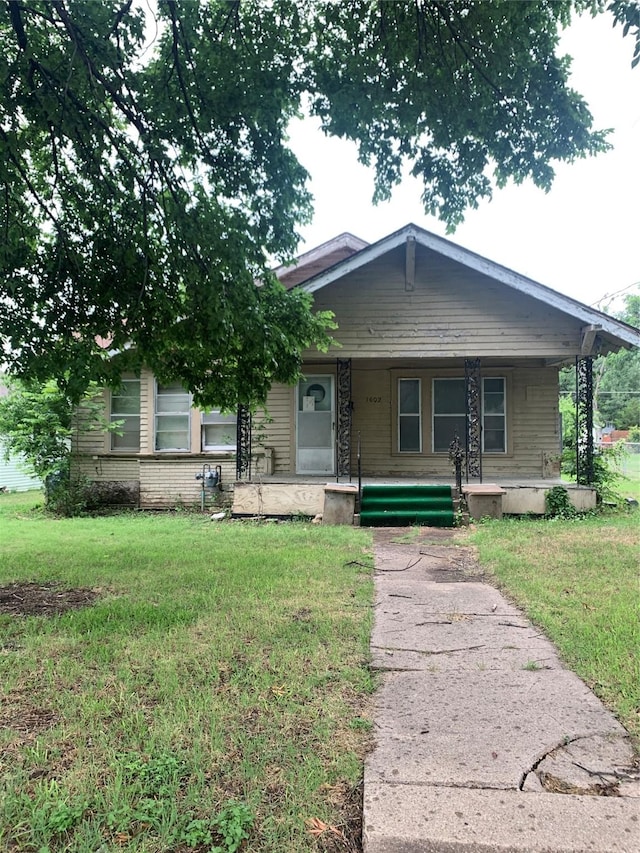 1602 Mitchell Ave, Waco, TX 76708 - view of front of home featuring a front yard and a porch