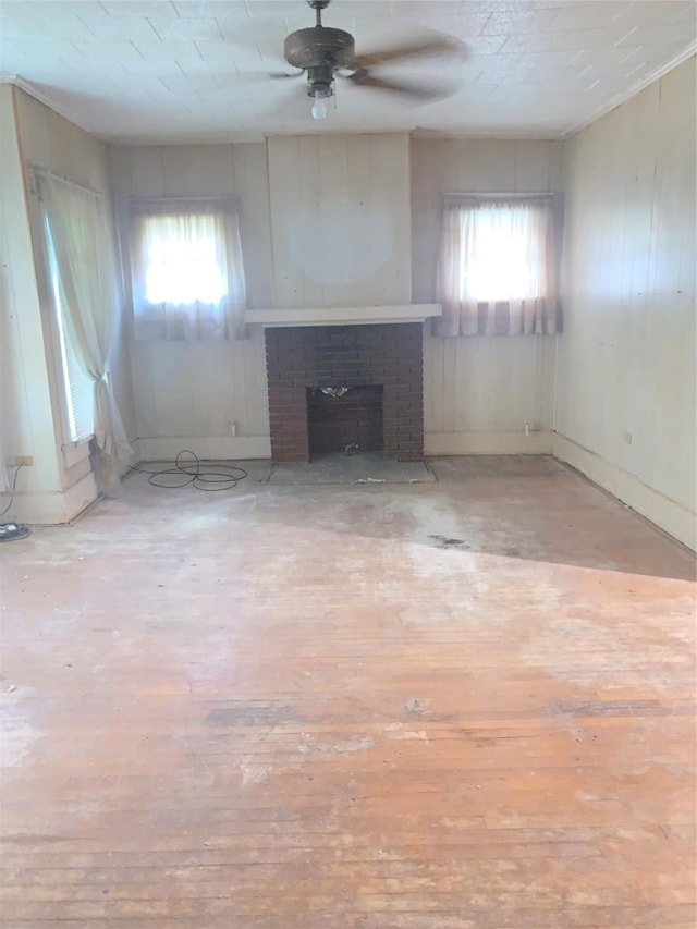 1602 Mitchell Ave, Waco, TX 76708 - unfurnished living room featuring a ceiling fan, a fireplace, wood finished floors, and baseboards