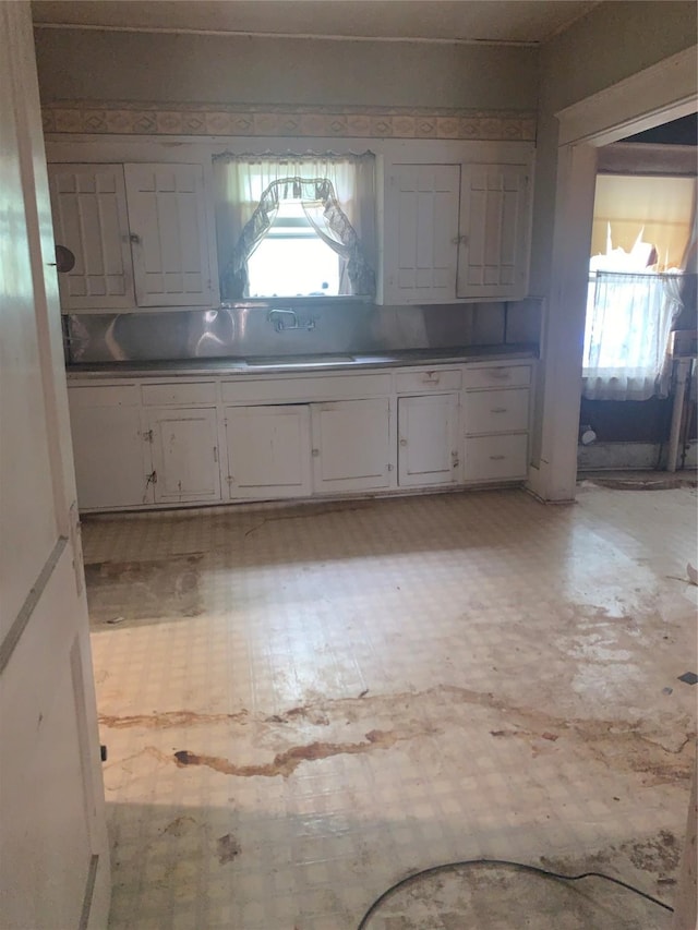 1602 Mitchell Ave, Waco, TX 76708 - kitchen featuring a sink, white cabinetry, and plenty of natural light