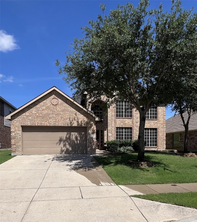 12428 Leaflet Dr, Fort Worth, TX 76244 - view of front of property with brick siding, driveway, a garage, and a front yard
