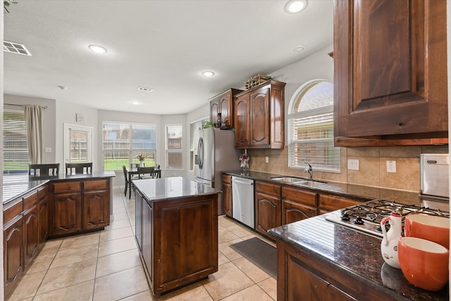 12428 Leaflet Dr, Fort Worth, TX 76244 - kitchen featuring stainless steel appliances, a center island, healthy amount of natural light, tasteful backsplash, and recessed lighting