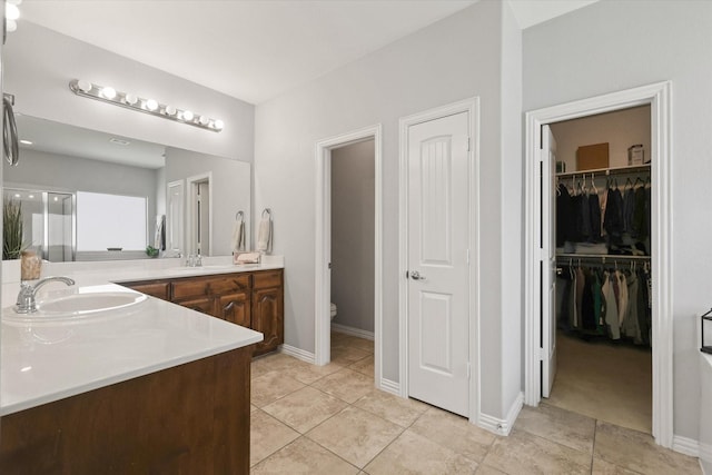 12428 Leaflet Dr, Fort Worth, TX 76244 - full bath featuring vanity, tile patterned flooring, a walk in closet, and baseboards